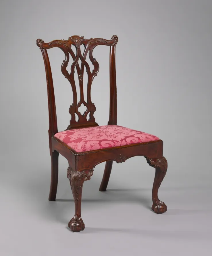A mahogany side chair with a pierced carved splat, cabriole front legs and ball-and-claw feet