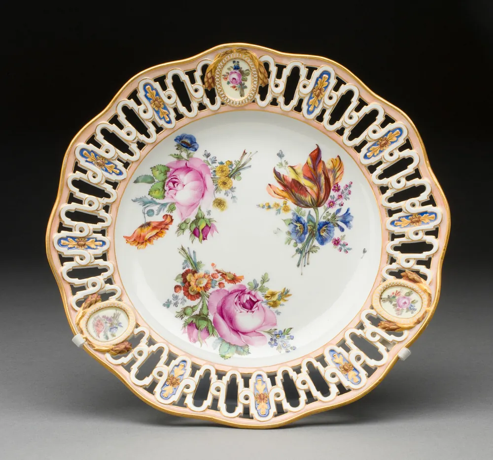 Meissen porcelain plate with delicate floral painting, pierced rim, and genuine factory marks